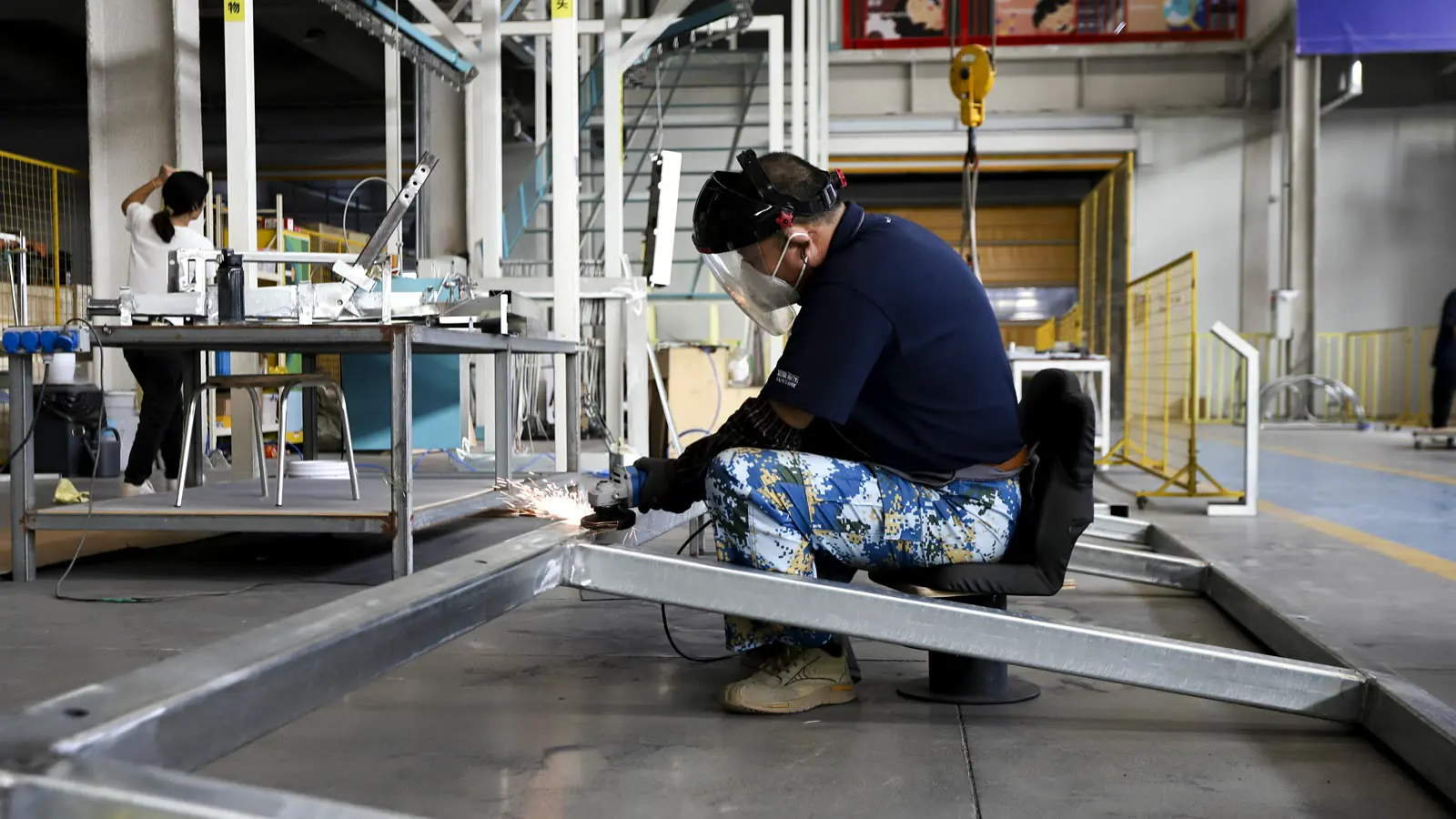 DEEPBLUE factory worker fabricating a metal exhibit structure for controlled whole museum manufacturing