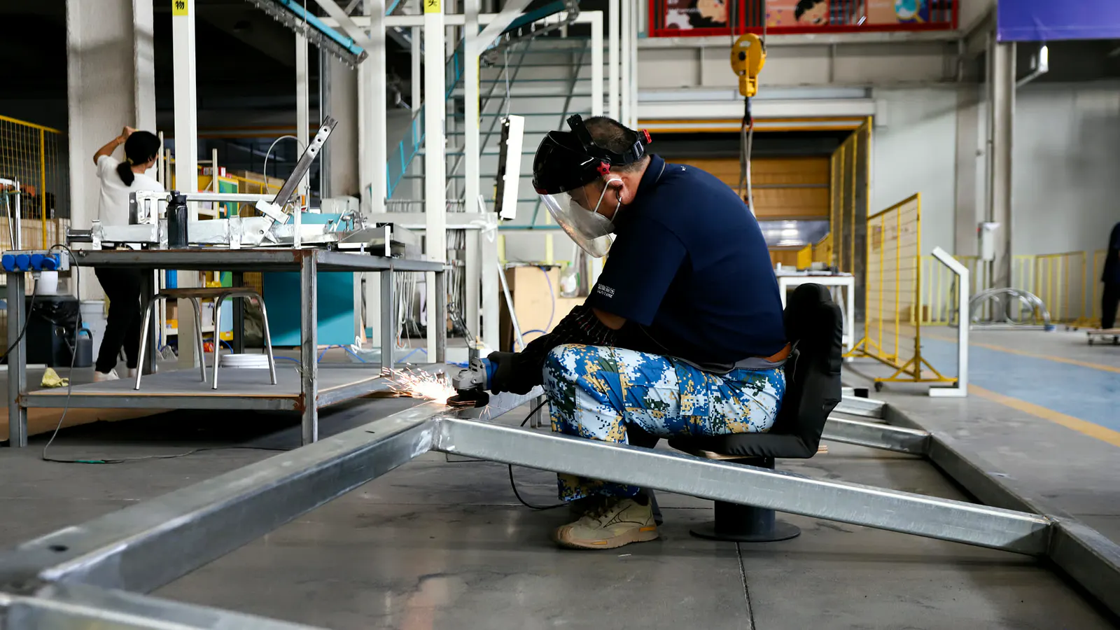 DEEPBLUE factory worker fabricating a metal exhibit structure from approved production information