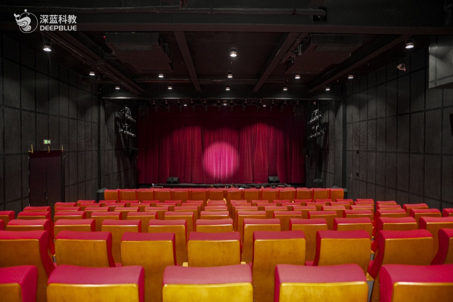 XPLOPLO first-floor WOW auditorium space with red seating