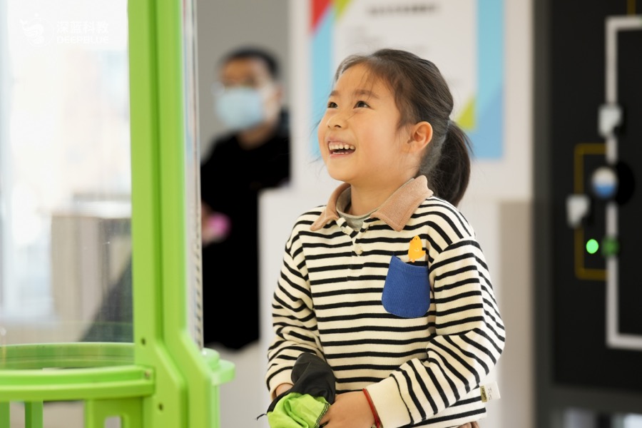 Children interacting with XPLOPLO exhibits in a bright learning space